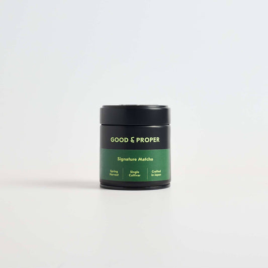 Green container of Good & Proper Signature Matcha (powdered green tea) on a white background